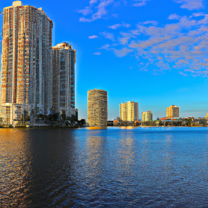 An image showcasing a panoramic view of Hollywood, Florida's vibrant skyline, with luxurious high-rise condominiums and waterfront properties glistening under the golden sun, reflecting the city's booming real estate industry